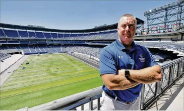  ?? BOB ANDRES / BANDRES@AJC.COM ?? New GSU coach Shawn Elliott, with the new football field at Georgia State Stadium (formerly Turner Field) behind him, is the Panthers’ third coach in their eight years of existence.