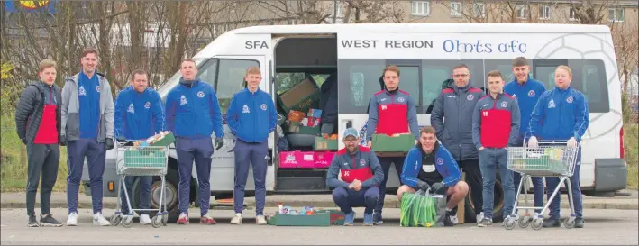  ?? Story and photograph­s: Derek Black. ?? Some of the Oban Saints Football Club members prepare for the food drop.