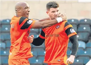  ??  ?? Mark Durnan, right, celebrates his equaliser with William Edjenguélé.