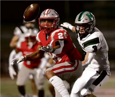  ?? KEN MCGAGH FOR THE GLOBE ?? Catholic Memorial’s Chris Sanchez (left) got into the act, scoring on a 20-yard intercepti­on return that was part of a 27-point flurry in the first 5:35 of a 41-14 rout over Mansfield.