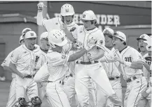  ?? Michael Minasi / Houston Chronicle ?? The Woodlands' PJ Villarreal, front left, and the Highlander­s had plenty to celebrate during their eight-run fourth inning.