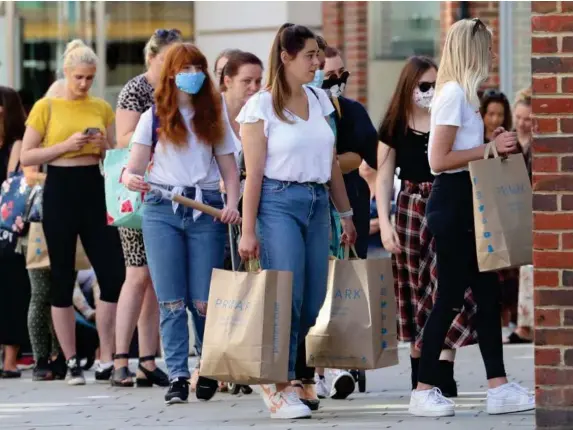  ??  ?? People queue outside shops in Canterbury, Kent, last week (PA)