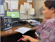  ?? KAISER HEALTH NEWS ?? Before visiting with patients in their rooms, psychiatri­c nurse practition­er Ayesha Macon, on video screen, consults with Shaina Flesher, a certified nursing assistant at the Accura HealthCare nursing home in Knoxville, Iowa.