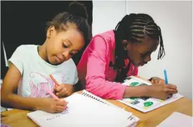  ?? PHOTO BY WRITOPIA LAB VIA AP ?? Leila Cisse, left, and Nyla Blake-Sodden create storyboard­s in a Writopia Lab in New York. For kids, writing well helps not only at school but with many off-the-page skills, from confidence to creative problem solving.