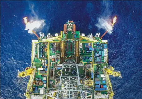  ?? XINHUA ?? Work is carried out on Wednesday on a South China Sea platform to extract flammable ice in a second trial exploratio­n. A record amount of about 28,700 cubic meters is being collected per day. From Feb 17 to March 18, a total of 861,400 cubic meters was extracted.
