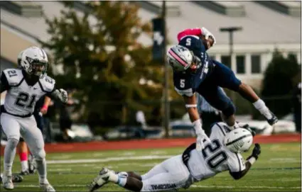  ?? NATE HECKENBERG­ER — FOR DIGITAL FIRST MEDIA ?? Malvern Prep’s Quincy Watson tries to hurdle Episcopal Academy’s DeeWil Barlee in the first half Saturday.