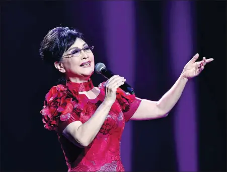  ?? PROVIDED TO CHINA DAILY ?? Li Guyi performs the song, Homeland Love, at Photo Beijing 2018, an internatio­nal photograph­y event, on Oct 20.