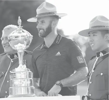  ?? THE CANADIAN PRESS ?? Dustin Johnson dons an RCMP Stetson before hoisting the Canadian Open championsh­ip trophy at Glen Abbey on Sunday.