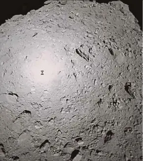  ?? AFP PIC ?? Picture showing the shadow of Japanese spacecraft Hayabusa2 (left) over the asteroid Ryugu yesterday.
