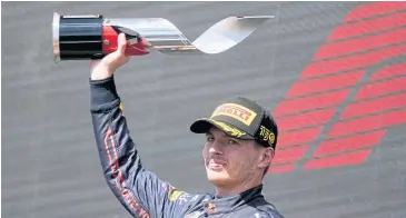  ?? AFP ?? Red Bull driver Max Verstappen celebrates with the Canadian Grand Prix trophy.