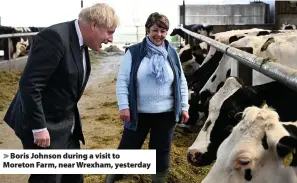  ??  ?? > Boris Johnson during a visit to Moreton Farm, near Wrexham, yesterday