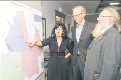  ?? MITCH MACDONALD/THE GUARDIAN ?? Stratford Electoral Boundaries Commission members, from left, Kirstin Lund, John McQuaid and Kevin Jenkins, look over their proposed ward boundary map that was presented to some members of the public on Tuesday night.