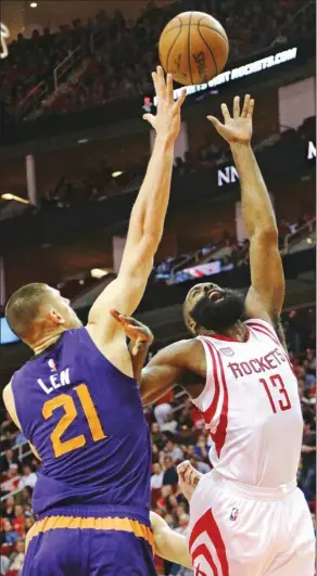  ?? BOB LEVEY / AP ?? Houston Rockets’ James Harden puts up a shot against Phoenix Suns‘ Alex Len in the first half of Monday’s NBA clash in Houston. Harden scored 32 points and dished out 12 assists as the Rockets won 131-115.