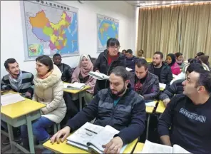  ?? ZHANG JIANCHENG / FOR CHINA DAILY ?? Overseas students take a Chinese language class at Yiwu Commercial and Industrial College in Zhejiang province.