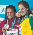  ??  ?? Kylie Masse (left) and Emily Seebohm at the world titles.