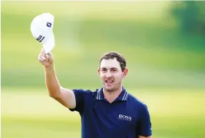  ?? The Associated Press ?? ■ Patrick Cantlay tips his cap to the crowd after winning the Tour Championsh­ip golf tournament and the FedEx Cup at East Lake Golf Club Sunday in Atlanta.