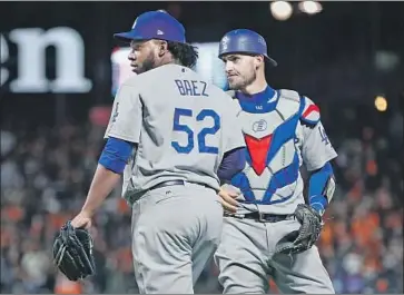  ?? Ezra Shaw Getty Images ?? DODGERS FANS have been disappoint­ed by the performanc­e of pitcher Pedro Baez, who watches with catcher Yasmani Grandal as the Giants score on a balk by Baez during the seventh inning on April 27.