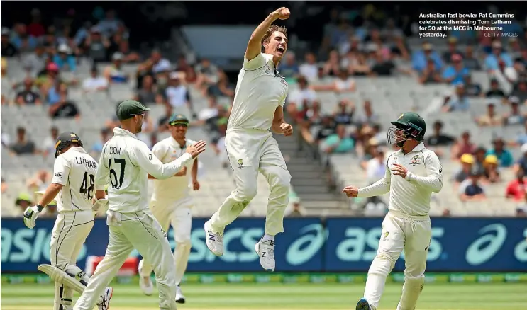  ?? GETTY IMAGES ?? Australian fast bowler Pat Cummins celebrates dismissing Tom Latham for 50 at the MCG in Melbourne yesterday.