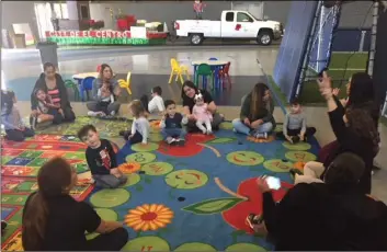  ?? PHOTO RICHARD MONTENEGRO BROWN ?? City of el Centro recreation leaders direct children, ages 3 to 5, and their parents through “circle time” at the Dr. Martin Luther King sports Pavilion on Monday in el Centro during the Camp rock class of the stepping stones program. stepping stones is an enrichment program run by the city of el Centro Parks and recreation Department. it is one of several programs running at a deficit as the city considers raising fees to offset those losses.