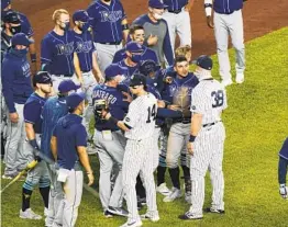  ?? KATHY WILLENS AP ?? The Rays and Yankees exchange words after a Rays loss on Sept. 1 during which Yankees reliever Aroldis Chapman threw near the head of Michael Brosseau.