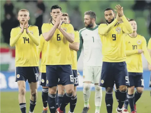  ??  ?? 0 Scott Mckenna, centre, impressed again in his second internatio­nal outing but it was Matt Phillips, right, who was the matchwinne­r.