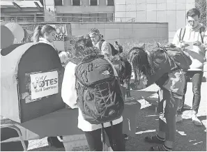  ?? CAT HOFACKER ?? Students at George Washington University drop off absentee ballots Oct. 18 at a “Party at the Mailbox” event.