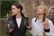  ?? ALESSANDRA TARANTINO — THE ASSOCIATED PRESS ?? Kateryna Prokopenko, wife of Denys Prokopenko, commander of the Azov regiment, right, and Yulia Fedosiuk, wife of Arseny Fedosiuk, another member of Azov regiment, get emotional as they show photos of their husbands on their phones during an interview in Rome on Friday.