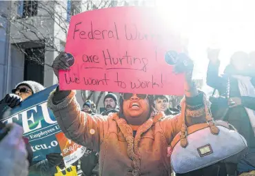  ?? Leigh Vogel / New York Times ?? Federal employees, contractor­s and supporters recently rallied in Washington, D.C., outside the AFL-CIO headquarte­rs, protesting a partial government shutdown. The closing is hurting Americans, they say.