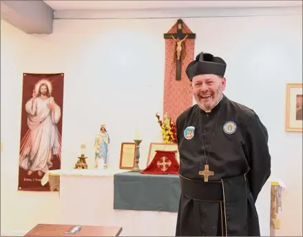  ?? Photos by Will Waldron / Times Union ?? Father Richard Russo in his new chapel at St. Helen Parish Mercy Center in Ballston Spa. The chapel, which seats 45 to 50 people, is located in the Union Mill Complex, also known as the former Bischoff’s Chocolate Factory building, at left.