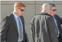  ?? RON MEDVESCEK/ASSOCIATED PRESS ?? Border Patrol agent Lonnie Swartz, left, makes his way to the U.S. District Court building in downtown Tucson in March.