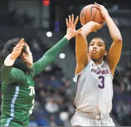  ?? Jessica Hill / Associated Press ?? UConn’s Megan Walker, right, shoots over Tulane’s Irina Parau in the second half during a game in February.