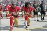  ?? MIKE MCCARN — THE ASSOCIATED PRESS FILE ?? 49ers Colin Kaepernick (7) and Eric Reid (35) kneel during the national anthem before a 2016 game in Charlotte, N.C. Colin Kaepernick and Eric Reid have reached settlement­s on their collusion lawsuits against the NFL, the league said Friday.