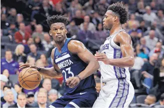  ?? STEVE YEATER/ASSOCIATED PRESS ?? Jimmy Butler (left), shown playing for Minnesota on Friday against Sacramento, will join the up-andcoming Philadelph­ia 76ers once the league approves the trade revealed on Saturday.