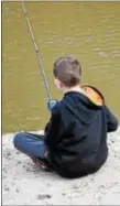  ?? ANNE NEBORAK – DIGITAL FIRST MEDIA ?? Zachary Lott, 12, of Aldan, is content waiting to catch his first fish along Darby Creek in Clifton Heights.