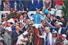  ?? Matt Stone/USA TODAY Sports ?? Jockey Javier Castellano celebrates aboard Mage in the Winner’s Circle as trainer Gustavo Delgado , with a hand on the garland of roses, won the 149th Kentucky Derby on Saturday at Churchill Downs in Louisville, Ky., on May 6.