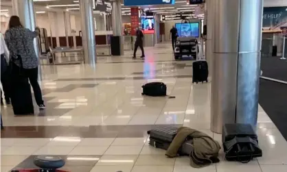  ?? Photograph: Brad Neal/Reuters ?? Luggage is seen on the ground at the Hartsfield-Jackson Atlanta airport on 20 November in an image obtained from a social media video.