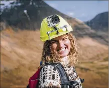  ?? KIRSTIN VANG / VISIT FAROE ISLANDS VIA AP ?? Kristina Sandberg Joensen, a tour guide for Visit Faroe Islands, wears a helmet fitted with a live-streaming camera, part of the tourist board’s Remote Tourism online experience, in Fyri Vestan, Faroe Islands.