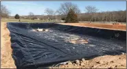  ?? (NWA Democrat-Gazette/Bennett Horne) ?? The first of three aquacultur­e ponds being built by the Property Owners Associatio­n below the Loch Lomond dam has been fitted with underlayme­nt and liner and will soon be ready for fish fingerling­s, which will eventually grow big enough to be stocked in the POA’s lakes.