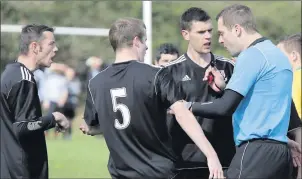  ??  ?? Newtown United players contest a decision by referee Gavin Colfer.