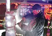  ?? [PHOTO BY PAT CHRISTMAN, THE FREE PRESS VIA AP] ?? Ice flies as Tom Schiller works on his reindeer Dec. 15 during an ice-sculpting competitio­n at the Kiwanis Holiday Lights display in Sibley Park in Mankato, Minn.