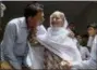  ?? FAREED KHAN - THE ASSOCIATED PRESS ?? Abdul Aziz Sheikh, left, father of Sabika Sheikh, a victim of a shooting at a Texas high school, comforts an elderly woman arriving for condolence to his daughter at his home in Karachi, Pakistan, Saturday. The Pakistani foreign exchange student is...