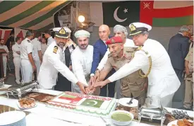  ?? (Muscat Daily) ?? H E Ali Javed (third from left) cuts the commemorat­ive cake with other dignitarie­s at the event