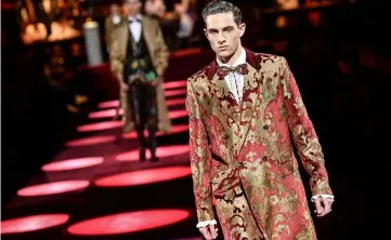  ??  ?? Models present creations for fashion house Dolce &amp; Gabbana during its Men’s Fall/Winter 2019/20 fashion show in Milan on Saturday. — AFP photos