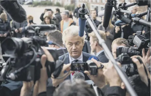  ?? PICTURE: GETTY IMAGES ?? 0 Geert Wilders, leader of the right-wing Party for Freedom, is mobbed by the press after casting his vote in The Hague