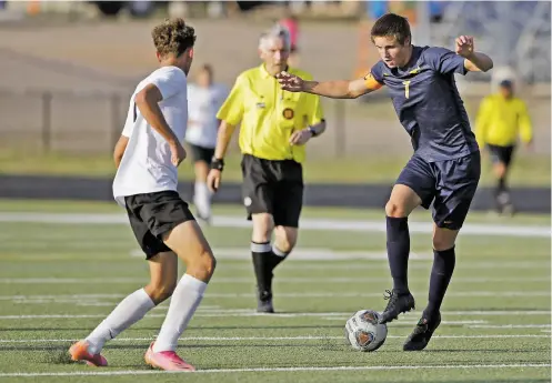  ?? PHOTOS BY LUIS SÁNCHEZ SATURNO/THE NEW MEXICAN ?? Albuquerqu­e Hope Christian’s Kaiden Giron, left, covers Santa Fe High’s Alex Waggoner during the first half of Tuesday’s match at Santa Fe High. It was Waggoner’s sixth straight match with a hat trick — he scored all of the Demons’ goals in their 3-2 win.