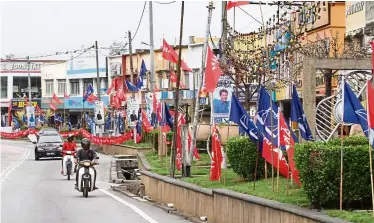  ??  ?? The show has started: Party flags and candidates posters are seen all the Rantau town.