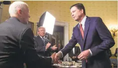  ?? AL DRAGO/THE NEW YORK TIMES ?? FBI Director James Comey greets Vice President Mike Pence and President Donald Trump during a Jan. 22 reception at the White House in Washington.