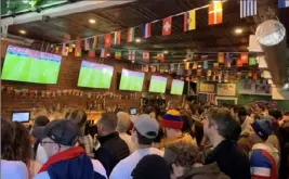  ?? Pittsburgh Post-Gazette ?? Soccer fans take in the U.S. men’s opening game of the World Cup on Monday at the Bulldog Pub in Morningsid­e.