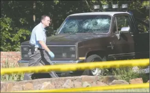  ?? The Sentinel-Record/Richard Rasmussen ?? CRIME SCENE: Hot Springs Police Detective Scott Lampinen works the scene of a fatal shooting at 101 Carla Circle Tuesday morning. A 24-year-old resident, Christophe­r Brock, was found deceased inside.