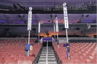  ?? CAROLYN KASTER/ASSOCIATED PRESS ?? State delegation signs are seen on the convention floor as preparatio­ns continue Saturday for the 2016 Democratic National Convention in Philadelph­ia.